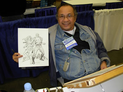 Ernie Chan, proudly holding his drawing of Doc and Pat Savage