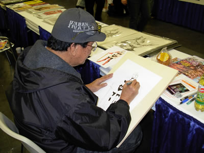 Alex Niño, drawing his version of Taarna
